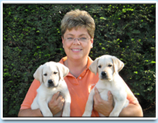 Image: Picture of Debbie Leach and two beautiful puppies.